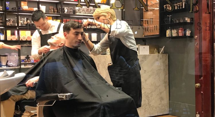 man sitting on barber chair